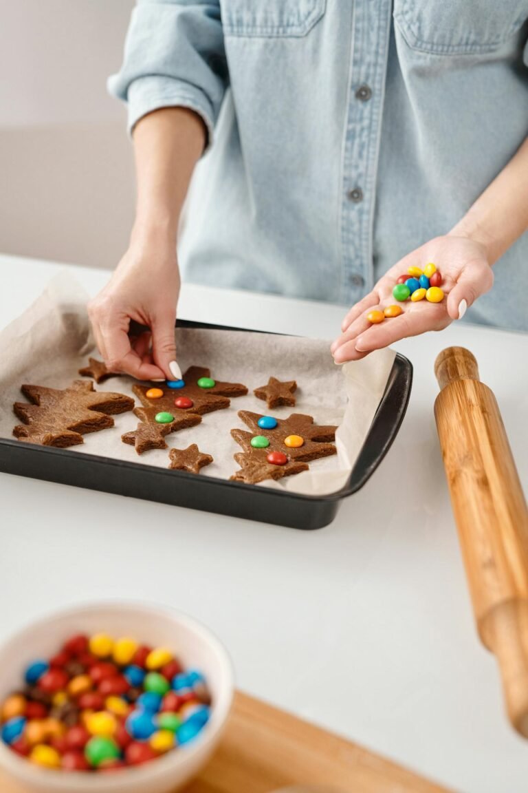 Hands decorating gingerbread cookies with colorful candies in a festive holiday setting.